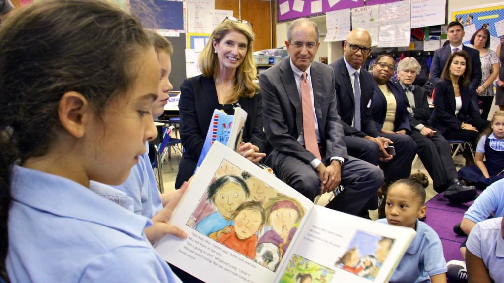 l_2017-09-28-e-lee-brian-and-aileen-roberts-philadelphia-hackett-school-donation-to-buy-books Comcast CEO Brian Roberts and his wife, Aileen (center), listen as Hackett School third-grader Madison Boudreaux reads. Through their foundation, the Robertses donated $450,000 to put books in Philadelphia public school classrooms. (Emma Lee/WHYY)