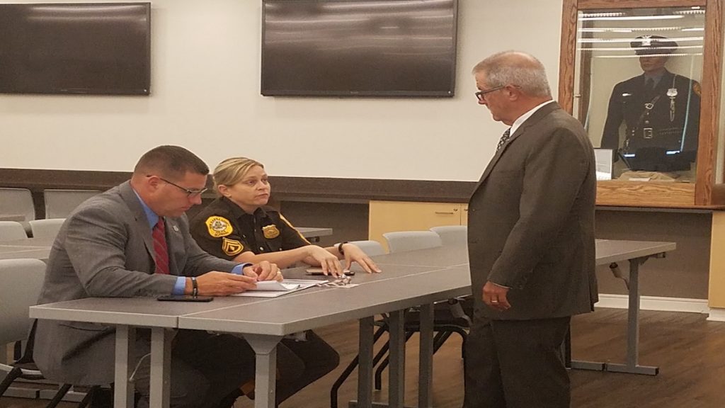 Det. Brian Shahan, M/Cpl., Heather Carter and Glenn Davis discuss New Castle County Cold Case Squad. (Andrea Gibbs/WHYY)