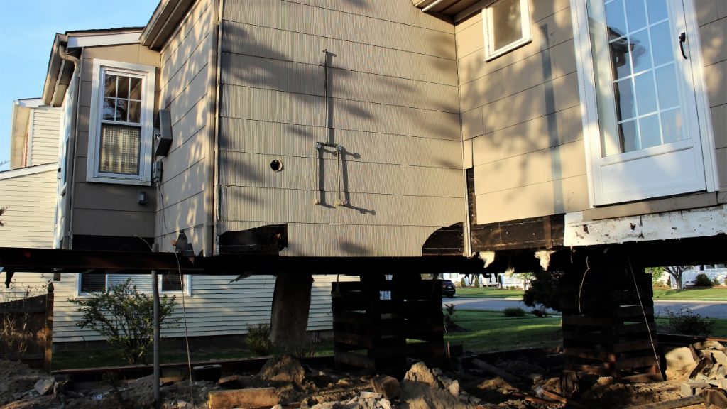 l_house-back- The author's home in the process of being elevated 5 feet higher.