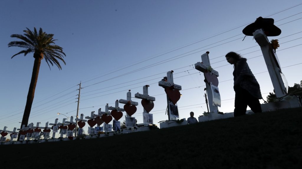 Las Vegas mass shooting A woman passes crosses set up to honor those killed during the mass shooting in Las Vegas.