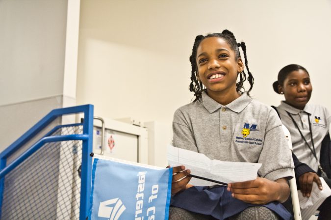 4th grade Mastery Cramer Hill Elementary student Anali Mitchell read her dreams for a better future before putting them into the time capsule. (Kimberly Paynter/WHYY)