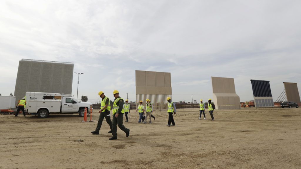 Border Wall People pass border wall prototypes as they stand near the border with Tijuana, Mexico, Thursday, Oct. 19, 2017, in San Diego.