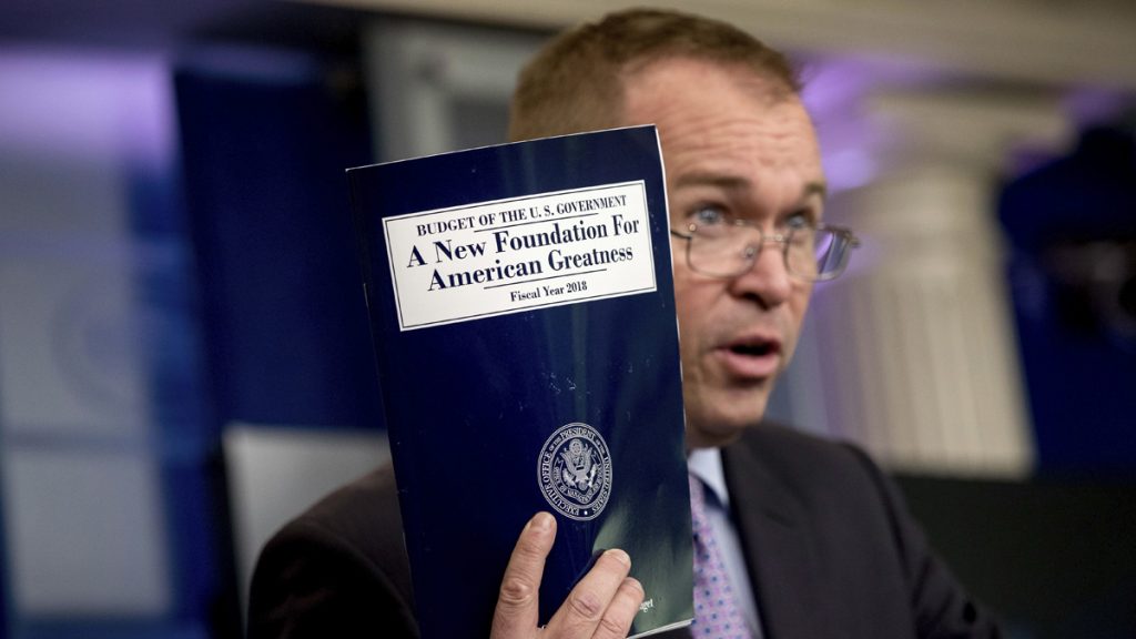 Mick Mulvaney Budget Director Mick Mulvaney holds up a copy of President Donald Trump's proposed fiscal 2018 federal budget. His $4.1 trillion plan for the budget year beginning Oct. 1 generally proposes deep cuts in safety net programs, including Medicaid and the Children's Health Insurance Program.