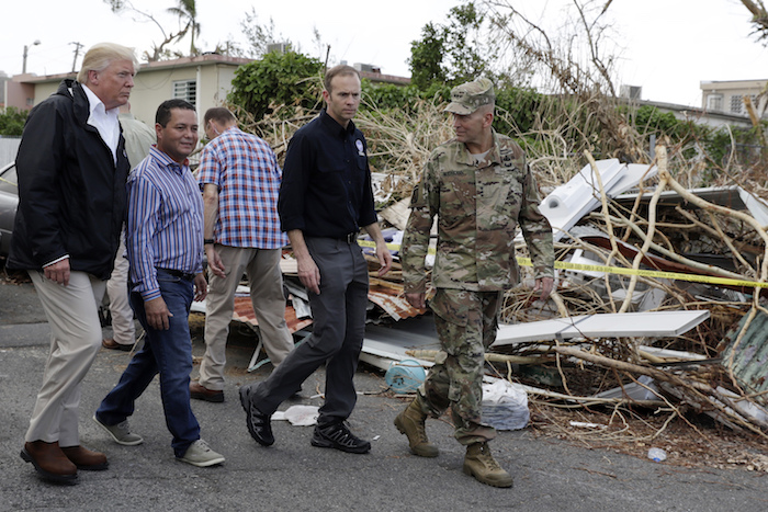APTOPIX Trump President Donald Trump takes a walking tour to survey hurricane damage and recovery efforts in a neighborhood in Guaynabo, Puerto Rico, Tuesday, Oct. 3, 2017. (AP Photo/Evan Vucci)