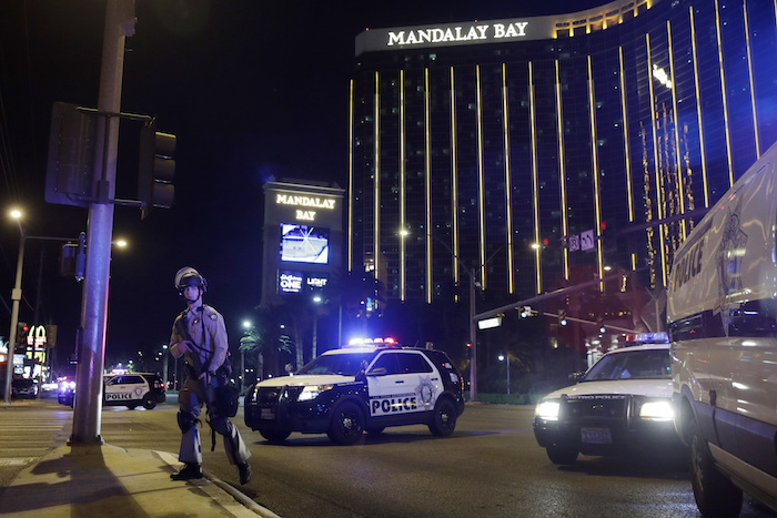 Las Vegas Shooting Police officers stand along the Las Vegas Strip the Mandalay Bay resort and casino during a shooting near the casino, Sunday, Oct. 1, 2017, in Las Vegas. (AP Photo/John Locher)