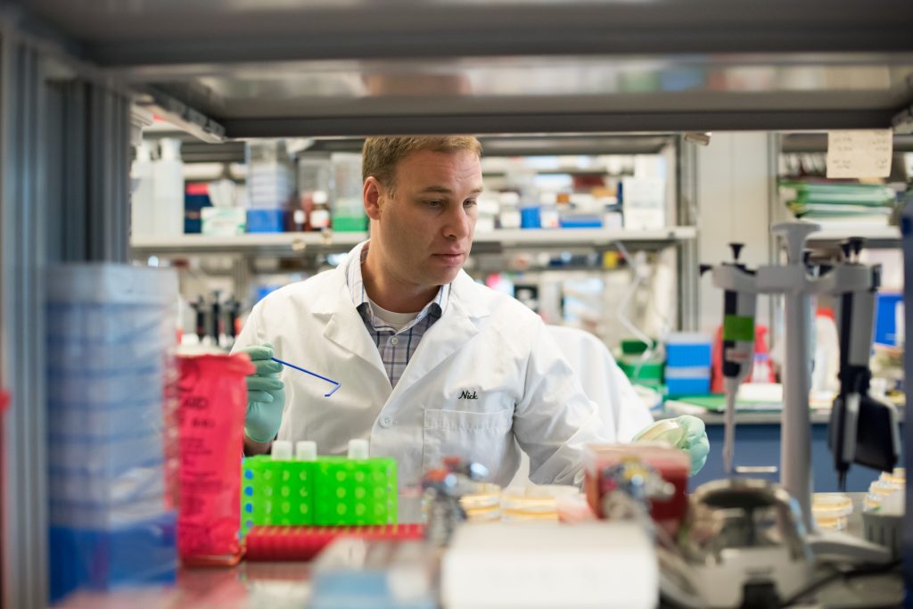 spark-media-kit-photo-3 A scientist in a white lab coat works in a Spark Therapeutics lab.