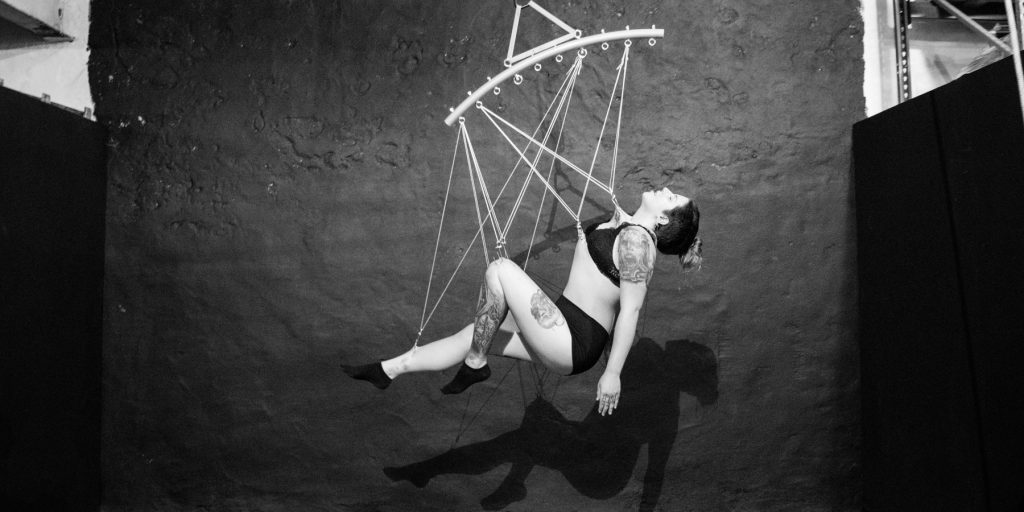 suspensionmain Kirsten Janusewski suspends by hooks in her skin at Skynthesis Body Suspension's studio in Easton, Pennsylvania. (Paige Pfleger/WHYY)