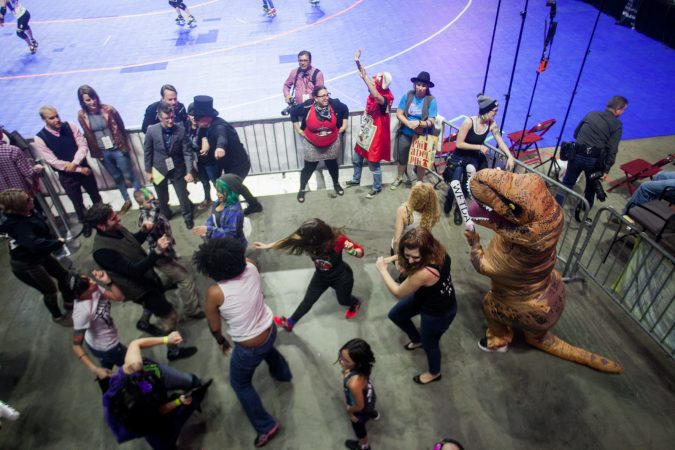 Roller derby fans dance between games at the WFTDA International Championship at the Liacouras Center. (Brad Larrison for WHYY)