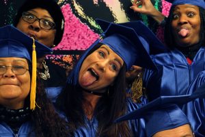 Redina Rodriguez (center) clowns for a photo with fellow graduates of the Women Working 4 A Change re-entry program.