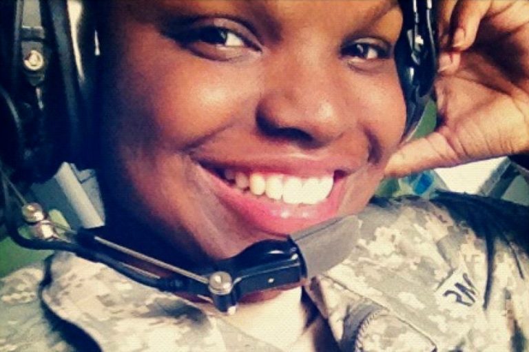 Pennsylvania National Guard veteran Darcel Rideout wearing camouflage uniform and headset smiles at the camera