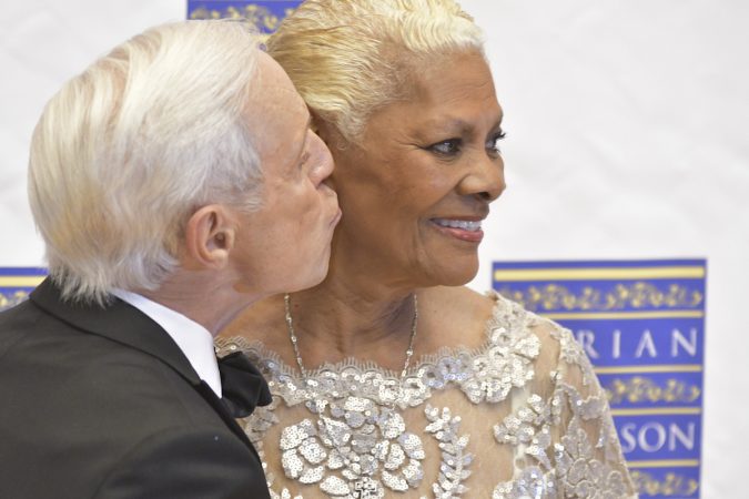 Event host Jerry Blavat and Marian Anderson Award recipient Dionne Warwick pose for photographers, ahead of a gala and award ceremony, on Tuesday, at the Kimmel Center. (Bastiaan Slabbers for WHYY)