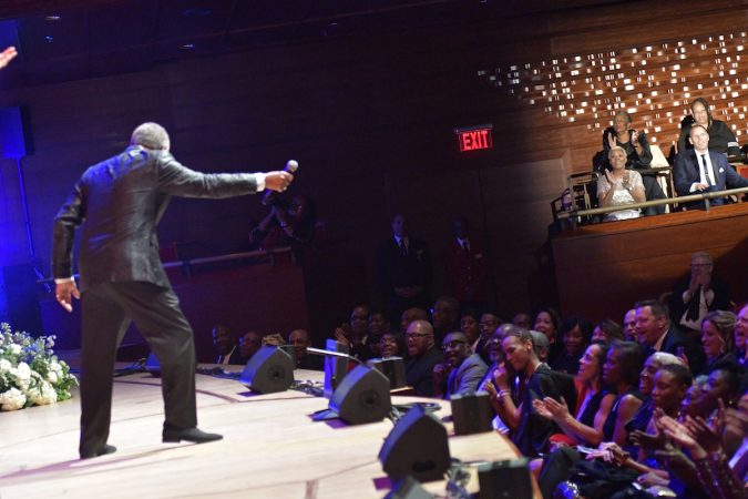 Billy Davis, Jr. holds out the mic as the spotlight hits Dionne Warwick at the Marian Anderson Award ceremony at the Kimmel Center, on Tuesday. (Bastiaan Slabbers for WHYY)