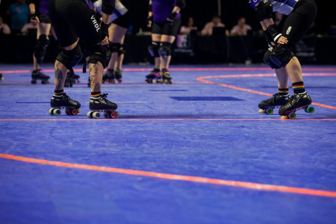 Players wait before restarting the WFTDA International Championship game at the Liacouras Center. (Brad Larrison for WHYY)