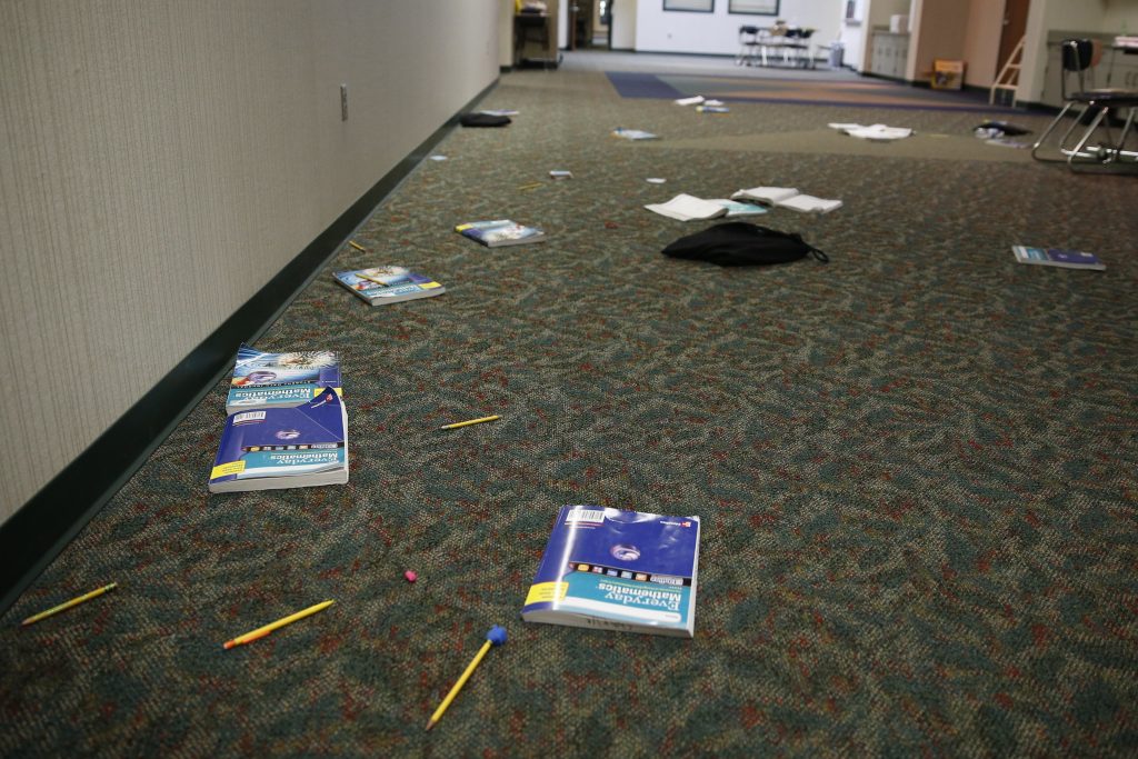 Schools Shooter Drills Photo, books and supplies litter the floor in this Indiana classroom during an intruder drill in 2016. Delaware requires schools to conduct two lockdown/active shooter drills a year. (Associated Press)