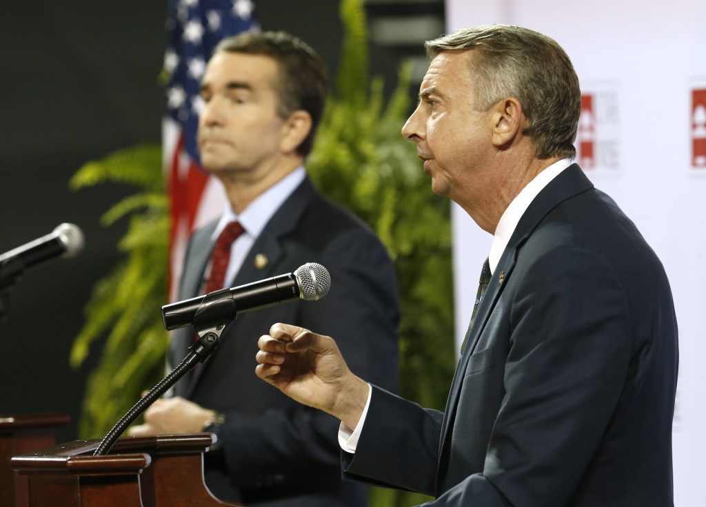Ralph Northam, Ed Gillespie Republican gubernatorial candidate Ed Gillespie, right, gestures during a debate with Democratic challenger Ralph Northam, left, during a debate at University of Virginia-Wise in Wise, Va., Monday, Oct. 9, 2017.
