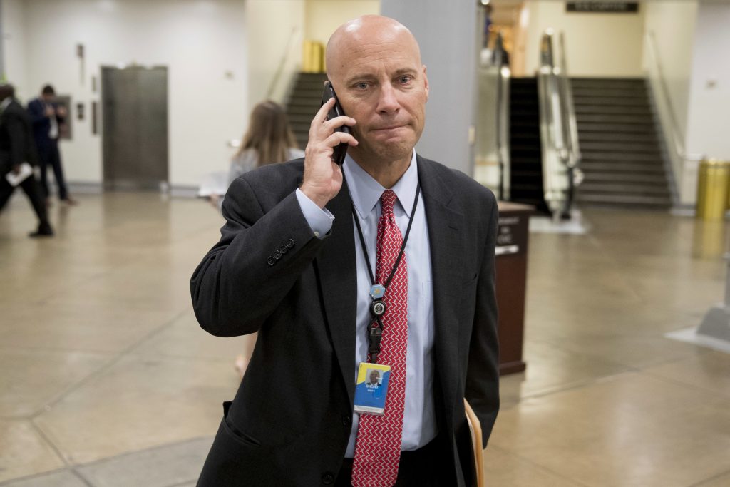 Trump White House legislative director Marc Short talks on the phone as he walks towards the Senate subway on Capitol Hill in Washington, Tuesday, Oct. 17, 2017.
