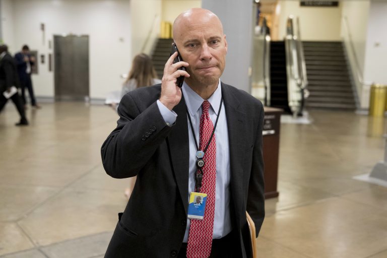 White House legislative director Marc Short talks on the phone as he walks towards the Senate subway on Capitol Hill in Washington, Tuesday, Oct. 17, 2017.