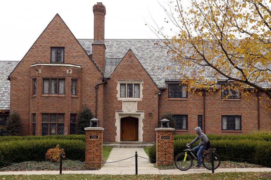 Fraternity House Deadly Fall A bicyclist rides past Pennsylvania State University's shuttered Beta Theta Pi fraternity house Thursday, Nov. 9, 2017, in State College, Pa. Centre County, Pa., District Attorney Stacy Parks Miller announced Monday, Nov. 13, 2017, that more charges have been filed against fraternity brothers after investigators recovered deleted surveillance video footage recorded before the Feb. 4, 2017, death of 19-year-old Tim Piazza, of Lebanon, N.J., after a night of heavy drinking.