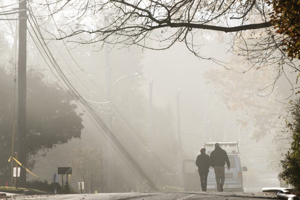 Senior Living Community Fire With smoke heavy in the air, a couple walks in the vicinity of a fire at the the Barclay Friends Senior Living Community in West Chester, Pa., Nov. 17. 2017. (Matt Rourke/AP Photo)
