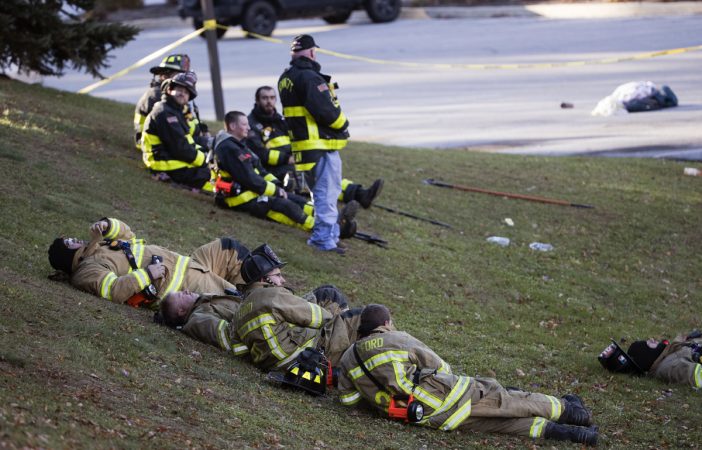 Firefighters rest in the aftermath of a fire at the the Barclay Friends Senior Living Community in West Chester, Pa., Friday, Nov. 17, 2017.  At least 20 people have been injured in a massive fire at the senior living community about 35 miles west of Philadelphia. (Matt Rourke/AP Photo)