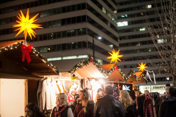 Shoppers browse stands at the Christmas Village at LOVE Park Friday. (Brad Larrison for WHYY)