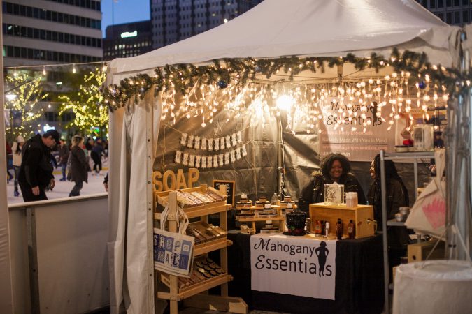 The Mahogany Essentials stand sells soaps and body essentials near the ice skating rink at Dilworth Park Friday. (Brad Larrison for WHYY)