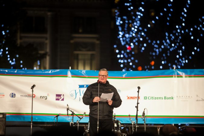 Philadelphia Mayor Jim Kenney reads The Night Before Christmas before the lighting of the Christmas tree outside of City Hall Friday. (Brad Larrison for WHYY)