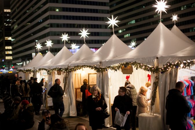 Shoppers browse stands at the Christmas Village in Dilworth Park Friday evening. (Brad Larrison for WHYY)