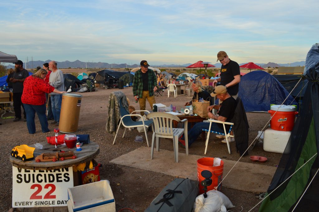 Camp-activity Volunteers and residents mingle in Camp Alpha at dinnertime.