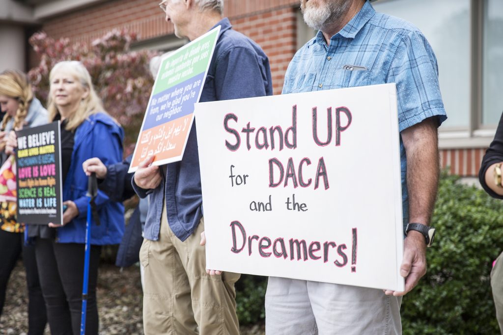 IMG_8141 Community members held signs in support of a DREAM act and DACA recipients outside Rep. Glenn Thompson's Centre County office in September. (Min Xian/Keystone Crossroads)