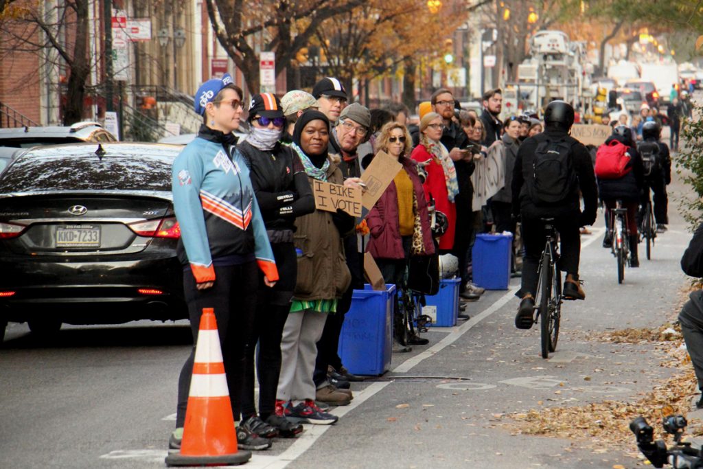 2017 11 29-e lee-philadelphia spruce street bike lane-protesters Protesters demanding protected bike lanes form a human barrier on Nov. 28, stretching for two blocks along Spruce Street near 11th Street, where a cyclist was killed by a garbage truck the previous morning. (Emma Lee/WHYY)