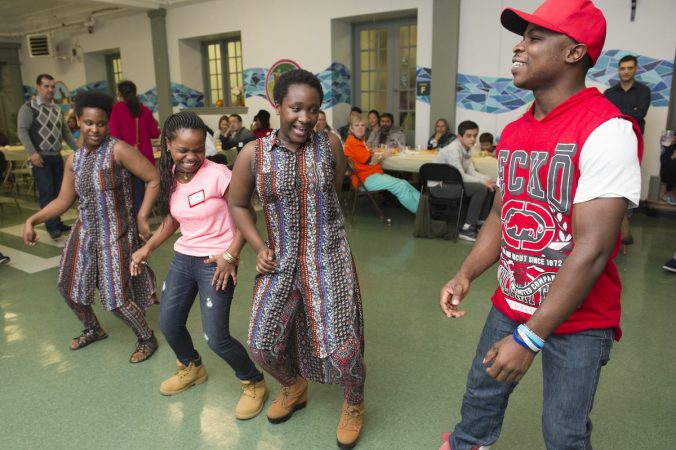 Bandu Pascal Lubria right, a refugee from the Democratic Republic of Congo dances with fellow refugees doing an African dance. (Jonathan Wilson for WHYY)