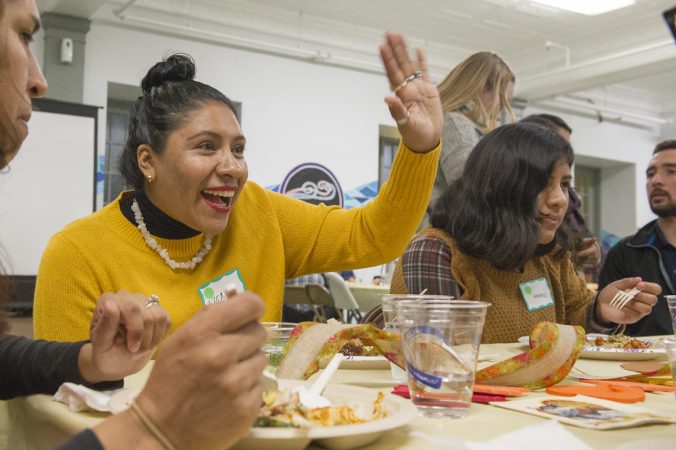 A mother and daughter, refugees from Mexico, enjoy their Thanksgiving dinner. (Jonathan Wilson for WHYY)