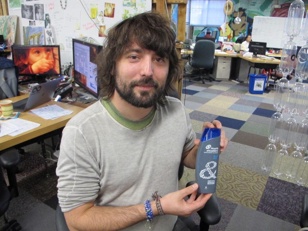 Szaky TerraCycle CEO Tom Szaky shows a shampoo bottle made with recycled plastic collected from beaches and oceans. (Phil Gregory/WHYY)