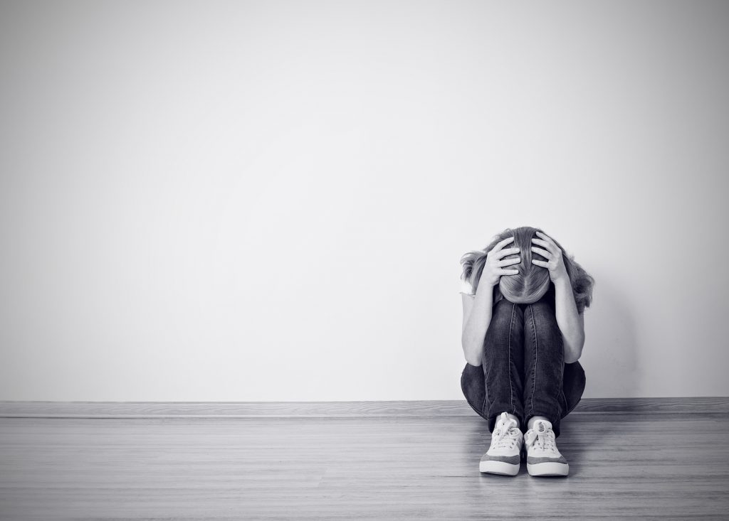 Girl Sits In A Depression On The Floor Near The Wall girl sits in a depression on the floor near the wall monochrome