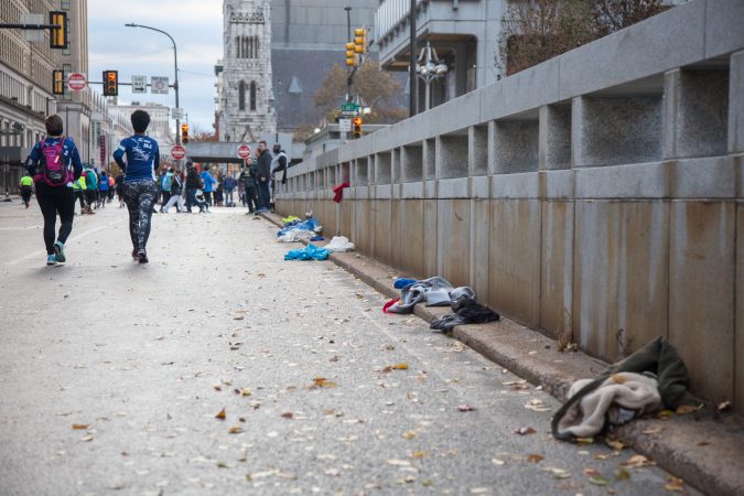 Discarded clothing, from runners who have warmed up, is collected by volunteers and donated to the city's homeless population.