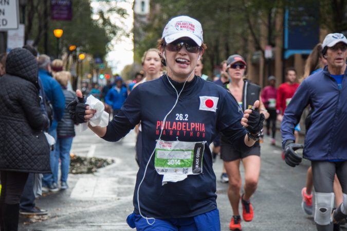 Eriko Ishibashi poses as she makes her way past mile six of the 23rd annual Philadelphia Marathon on Sunday November 19th, 2017.