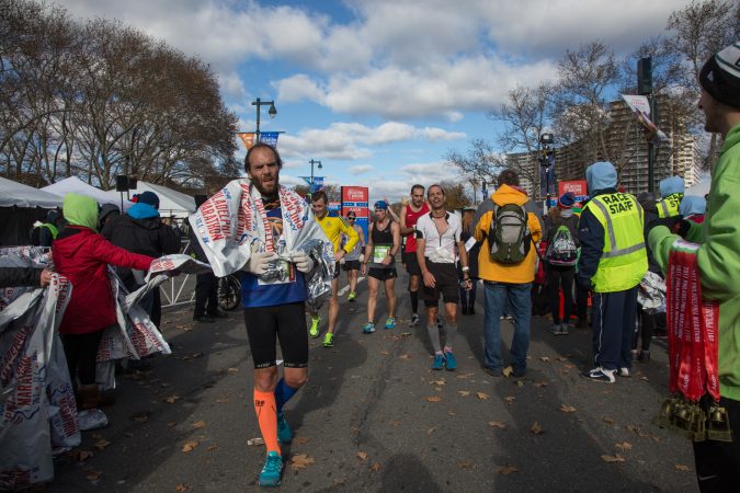 Racers walk for the first time in over two hours as they cross the finish line at the 23rd annual Philadelphia Marathon on Sunday November 19th, 2017.