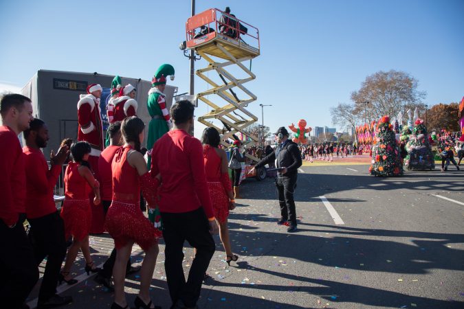 A worker gives stage directions to dancers performing for the 6abc broadcast of the 98th annual Philadelphia Thanksgiving Day Parade, November 23, 2017. (Emily Cohen for WHYY)