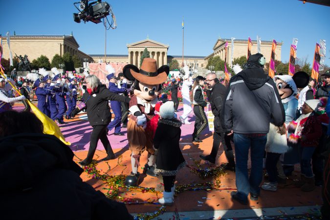 Mickey Mouse says hi to a child before going on stage at the 98th annual Philadelphia Thanksgiving Day Parade, November 23, 2017. (Emily Cohen for WHYY)