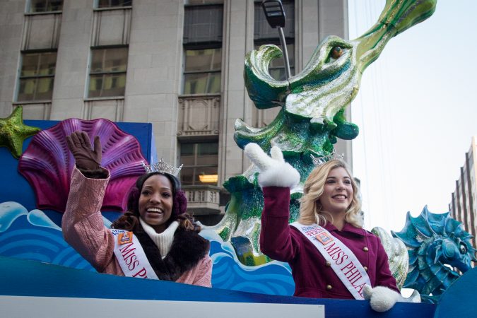 Miss Philadelphia, Nia Andrews, (left), and Miss Teen Philadelphia, Julia Rae Schlucter, (right), wave at the crowd during the 98th annual Philadelphia Thanksgiving Day Parade, November 23, 2017. (Emily Cohen for WHYY)