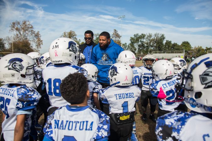 Rickey Duncan, center, helps pump up his 6U team before their game.