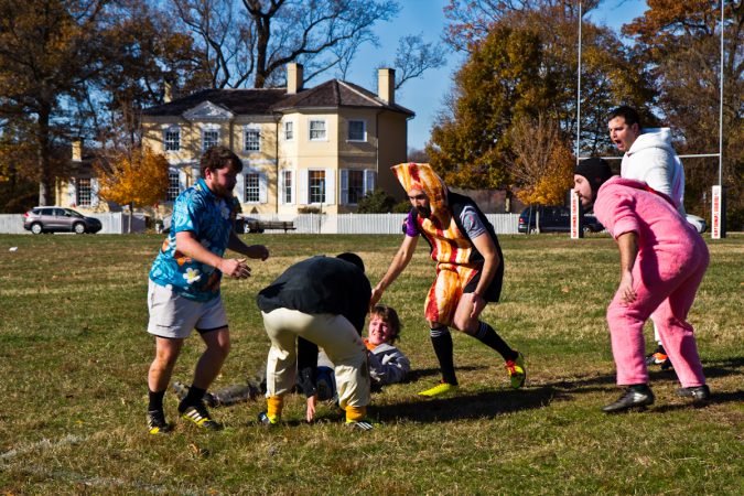The Handsome Gents battle the Northeast Irish at the Apple Pie 7s Rugby Tournament in Fairmount Park. (Kimberly Paynter/WHYY)