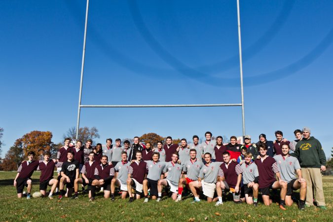 St. Joe’s Prep alum rugby players pose for a team pic at the 9th annual Apple Pie 7s Rugby Tournament in Fairmount Park. (Kimberly Paynter/WHYY)