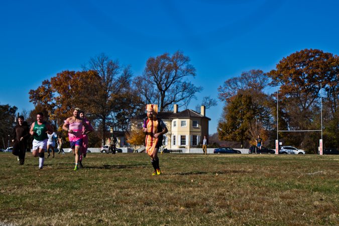 The Handsome Gents battle the Northeast Irish at the Apple Pie 7s Rugby Tournament in Fairmount Park. (Kimberly Paynter/WHYY)