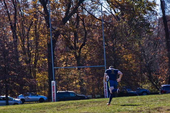 The Handsome Gents battle the Northeast Irish at the Apple Pie 7s Rugby Tournament in Fairmount Park. (Kimberly Paynter/WHYY)