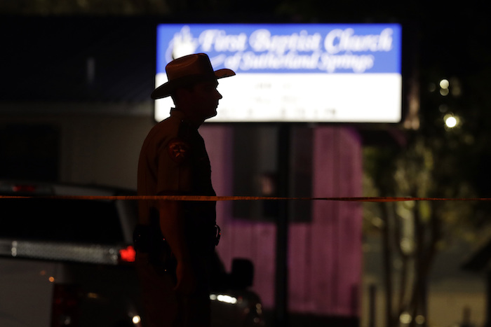 A law enforcement official stands watch outside the First Baptist Church of Sutherland Springs, the scene of a mass shooting, Sunday, Nov. 5, 2017, in Sutherland Springs, Texas. A man dressed in black tactical-style gear and armed with an assault rifle opened fire inside the church in the small South Texas community on Sunday, killing and wounding many. The dead ranged in age from 5 to 72 years old. (AP Photo/Eric Gay)
