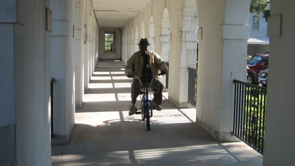 Simeon Peterson, known as “Mr. Pete,” in 2009. Patients at Carville leprosarium often used bicycles to get from building to building, which were connected by covered passageways. Simeon Peterson, known as