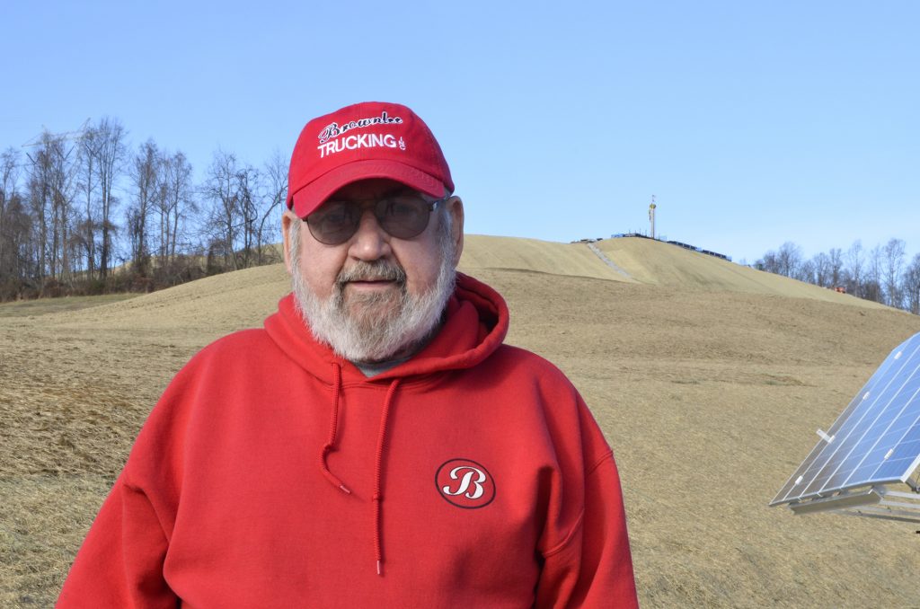 122117-frank-brownlee Washington County resident Frank Brownlee stands in his backyard, where a rig on the hill behind him is drilling natural gas wells. (Amy Sisk/StateImpact Pennsylvania)