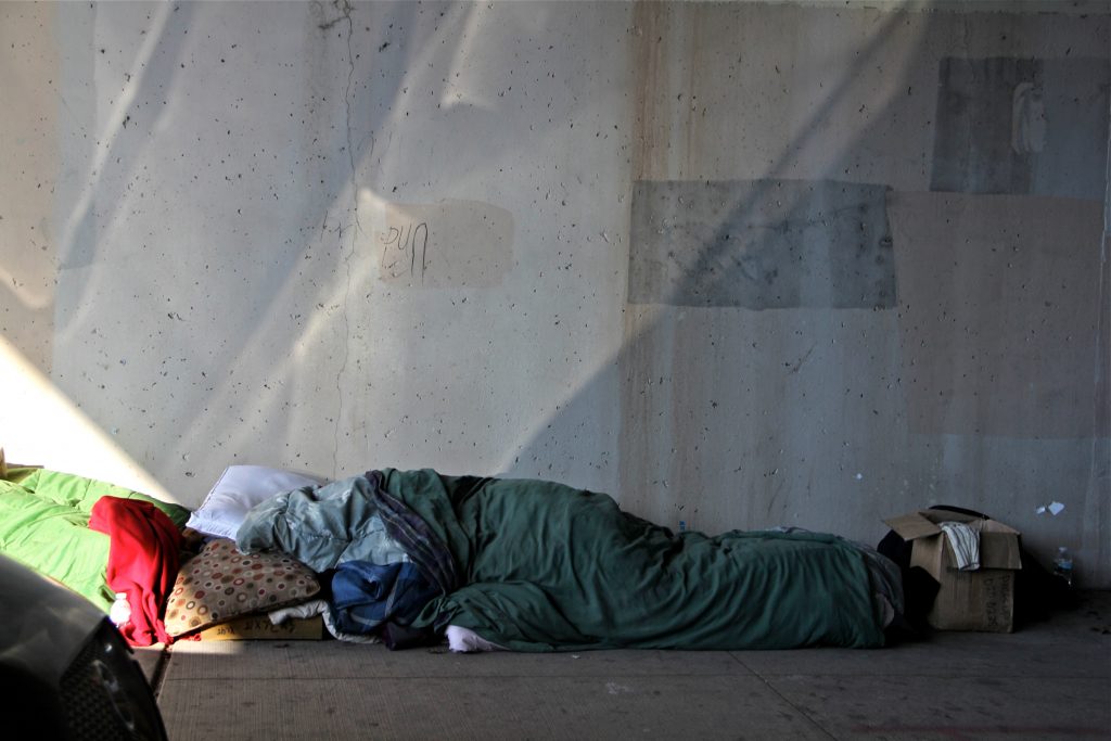 A homeless person takes shelter under an overpass on North 5th Street.
